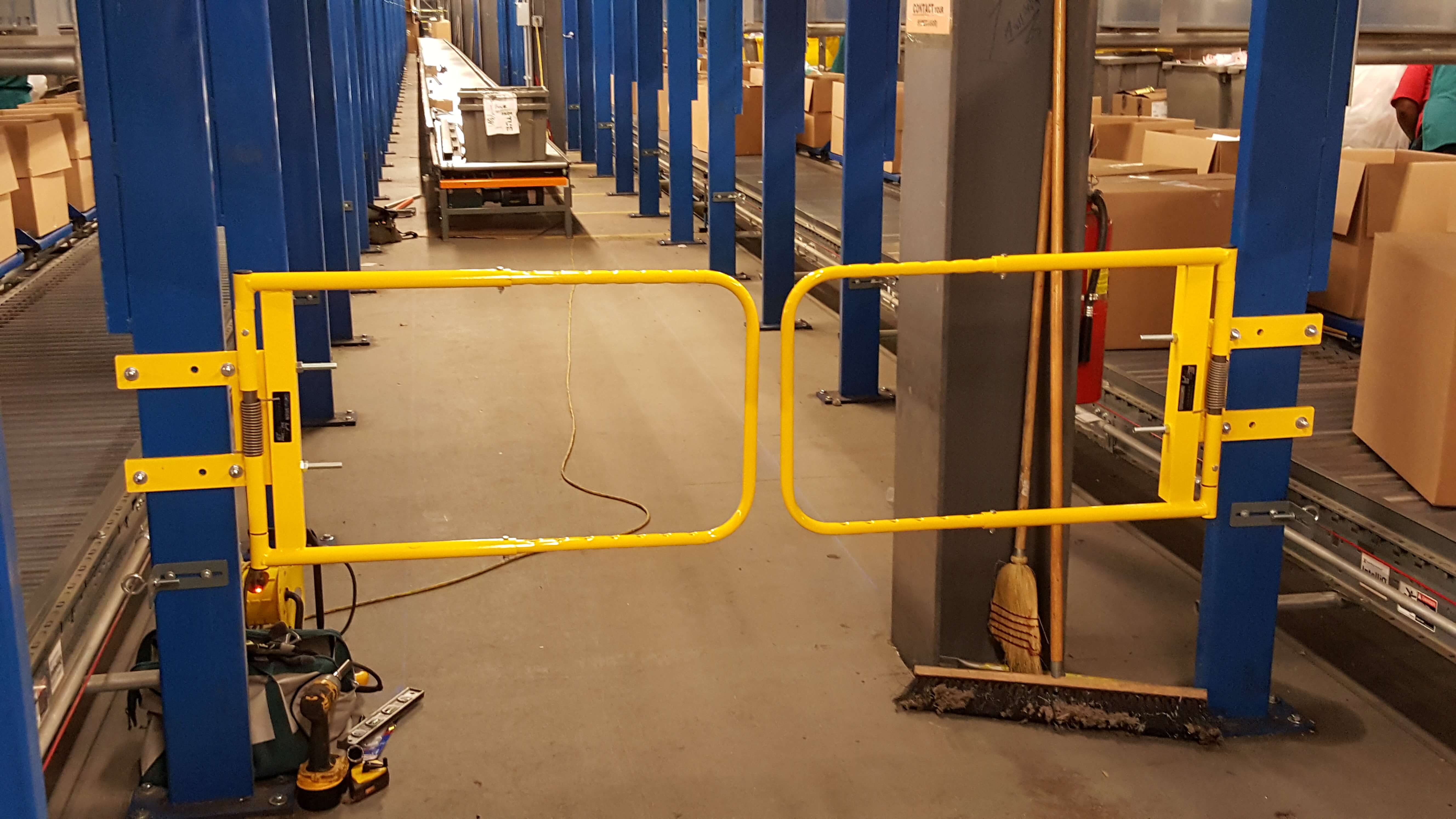 Industrial Safety Swing Gates next to conveyor saloon door style
